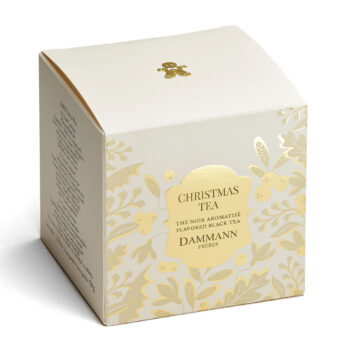 Boîte de Christmas Tea Dammann Frères, thé noir aromatisé orné de motifs floraux dorés et d'un petit bonhomme en pain d'épices
