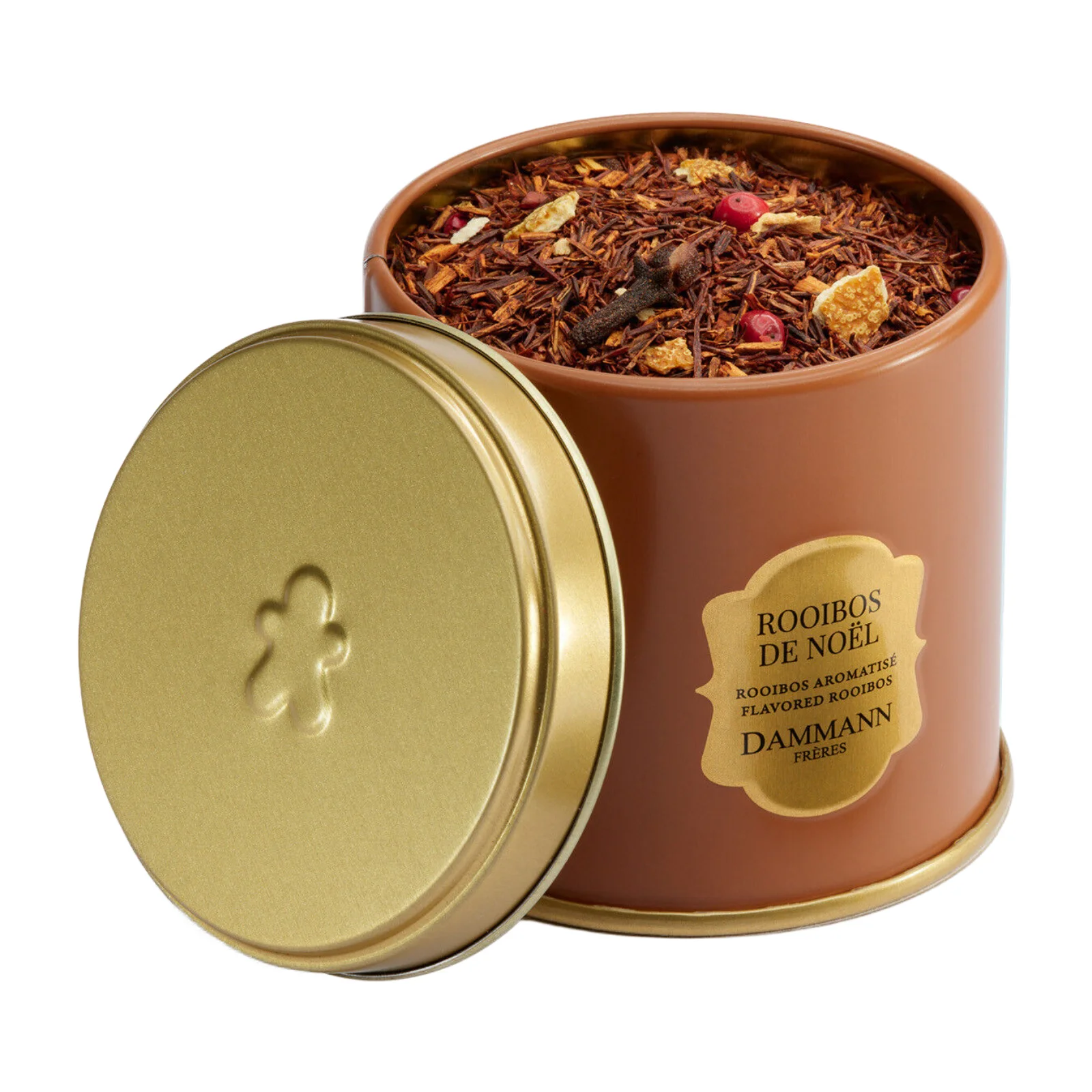 Boîte métallique de Rooibos de Noël Dammann Frères ouverte, dévoilant un mélange de thé avec des morceaux d'agrumes, des clous de girofle et des baies