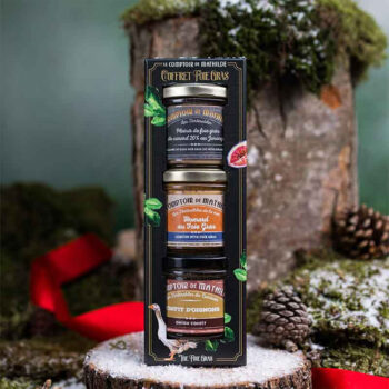 Coffret cadeau Le Comptoir de Mathilde avec trois pots de tartinables : foie de canard, homard au foie gras et confit d'oignons, décoré de motifs festifs.