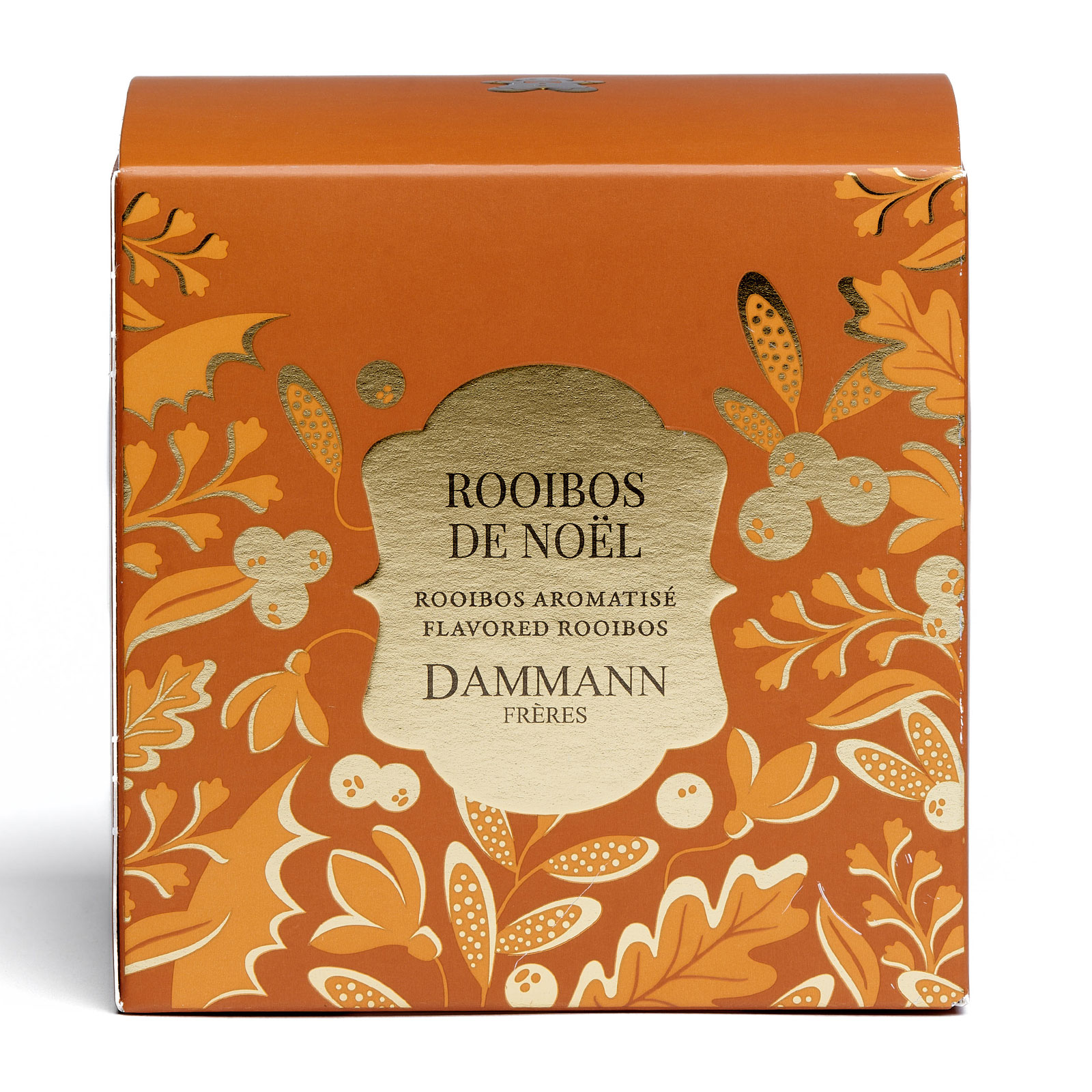 Boîte de Rooibos de Noël Dammann Frères, emballage orange festif avec des motifs floraux et des baies, contenant du rooibos aromatisé au pain d'épices