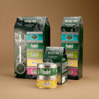 Coffret cadeau Kusmi Tea composé de boîtes de thé vert colorées et d'emballages en carton vert décorés de motifs tropicaux