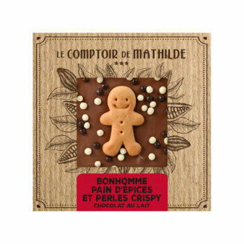 Tablette de chocolat au lait Le Comptoir de Mathilde avec bonhomme en pain d’épices et perles crispy dans un emballage festif en carton kraft.