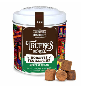 Boîte de Truffes de Noël du Comptoir de Mathilde au chocolat au lait, noisette et feuilletine, avec quelques truffes à côté