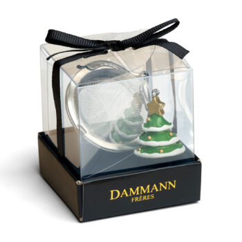 Boule à thé Dammann Frères argentée avec décoration Sapin de Noël, sur base noire logo doré