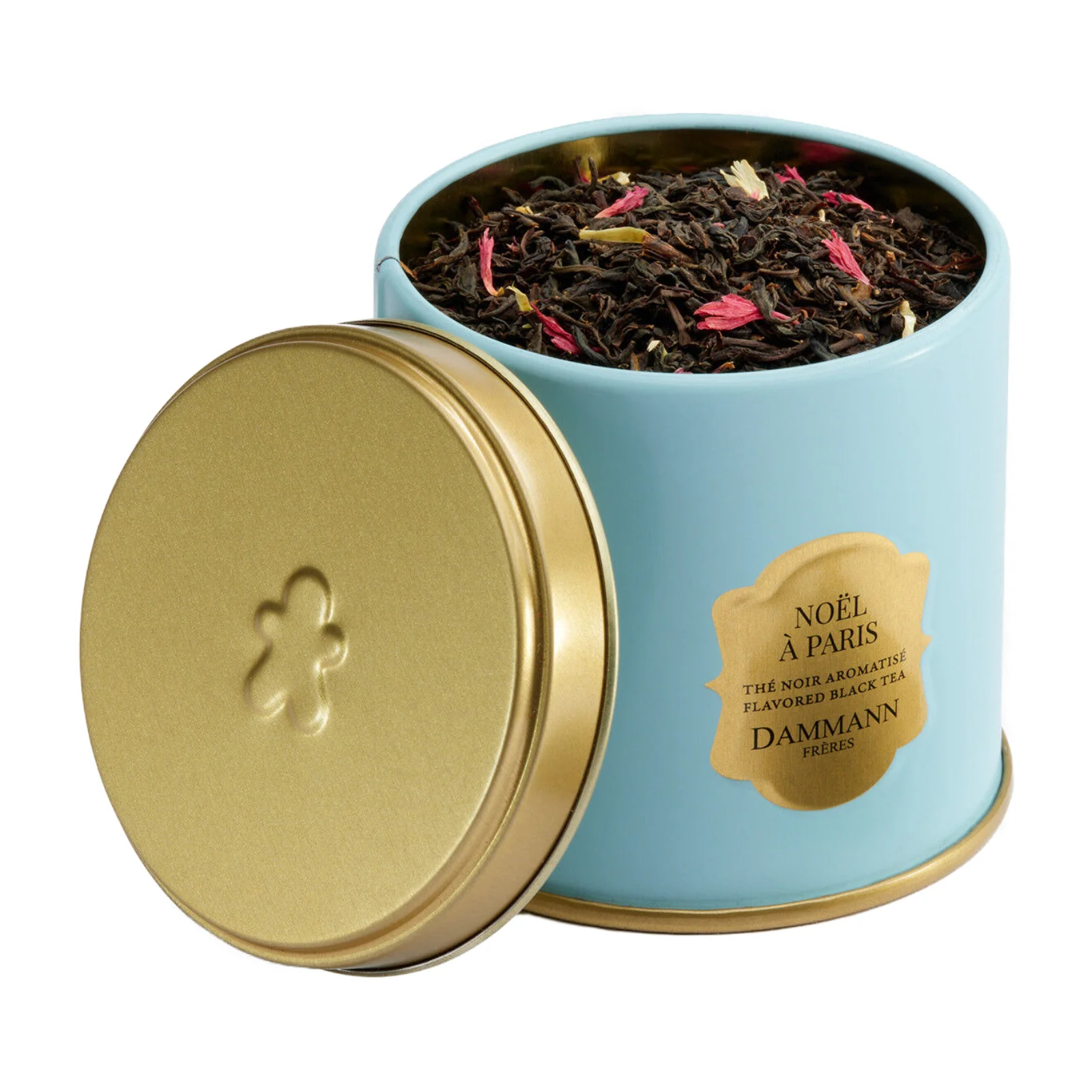 Boîte métal bleue Dammann Frères Noël à Paris 100g, ouverte, contenant du thé noir en vrac avec des pétales rouges et jaunes