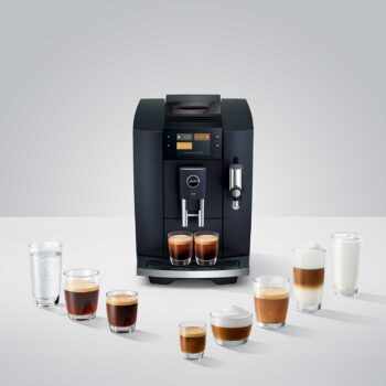 Machine à café JURA E8 Cosmic Black entourée de verres de différentes préparations de café, dont des expressos, cappuccinos et un verre d'eau