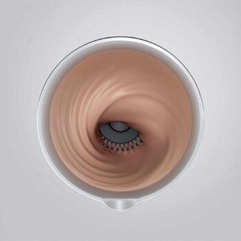 Vue de dessus d'un émulsionneur de lait JURA en action, créant un tourbillon de lait crémeux brun clair avec un élément de mélange noir au centre