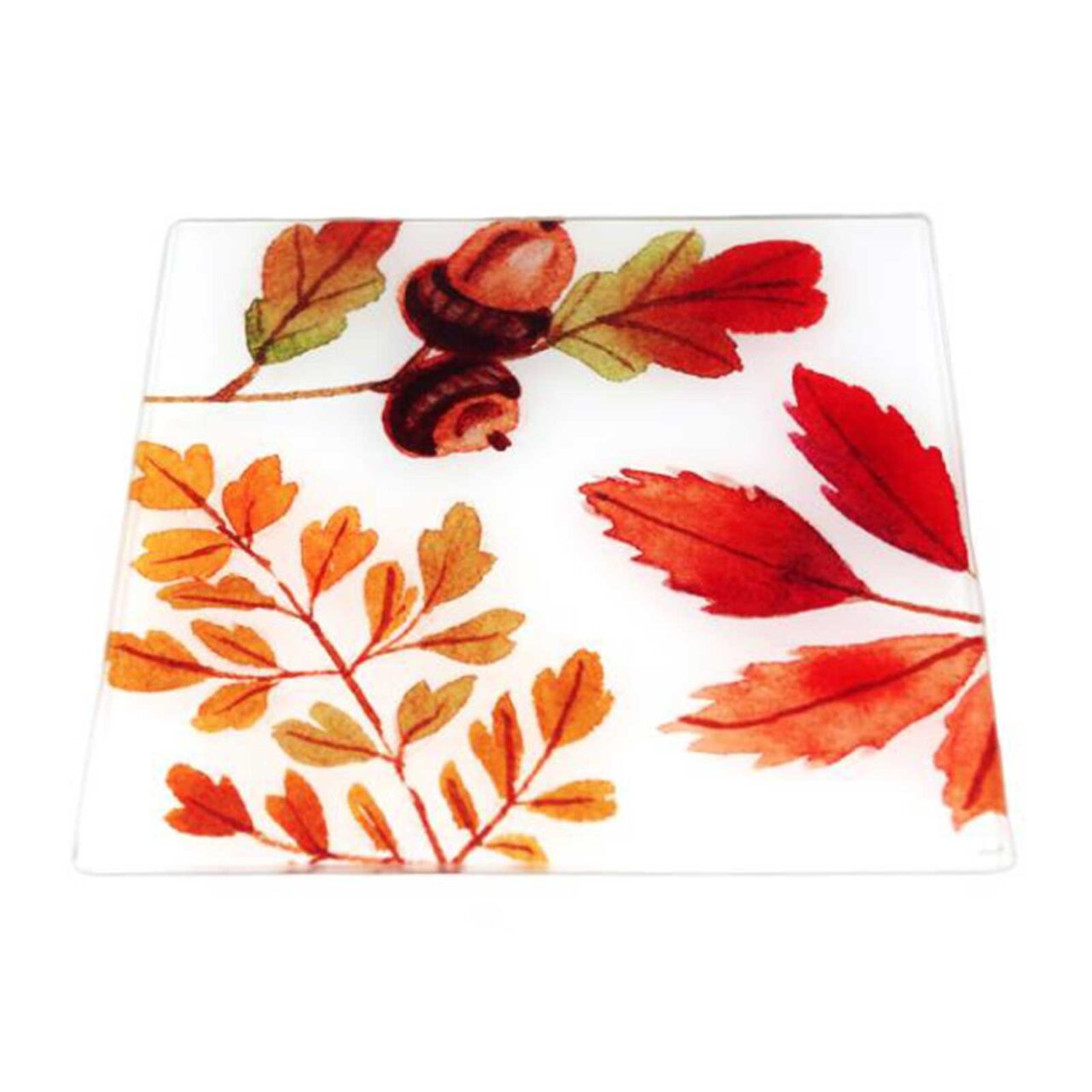 Dessous de plat carré en verre transparent, motif automnal de feuilles colorées et glands bruns, format 20 x 20 cm.